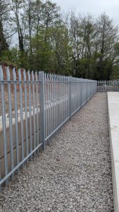Galvanised palisade fence system surrounding industrial site